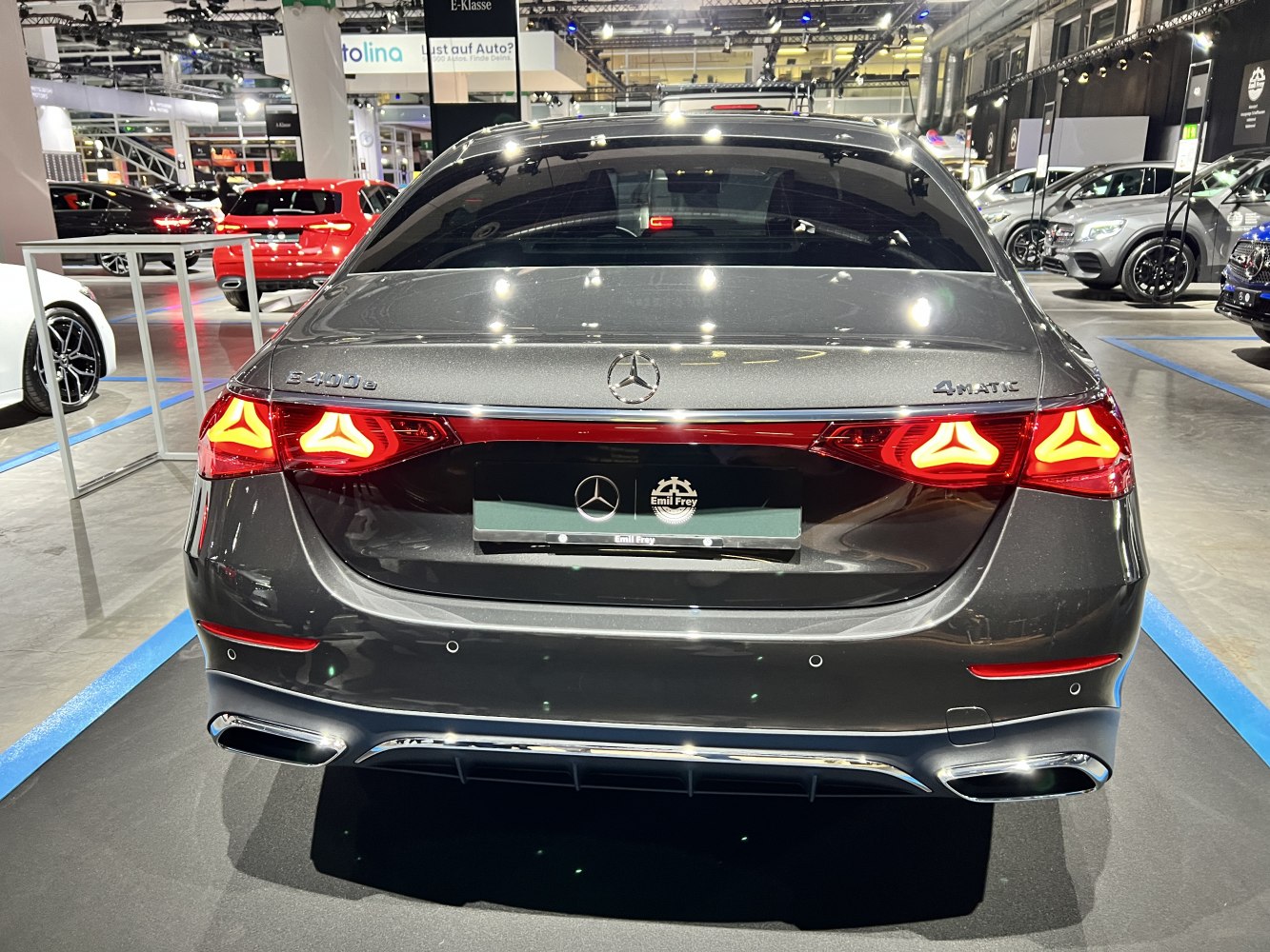 Rear view of a luxury sedan with triangular LED taillights and dual exhaust outlets