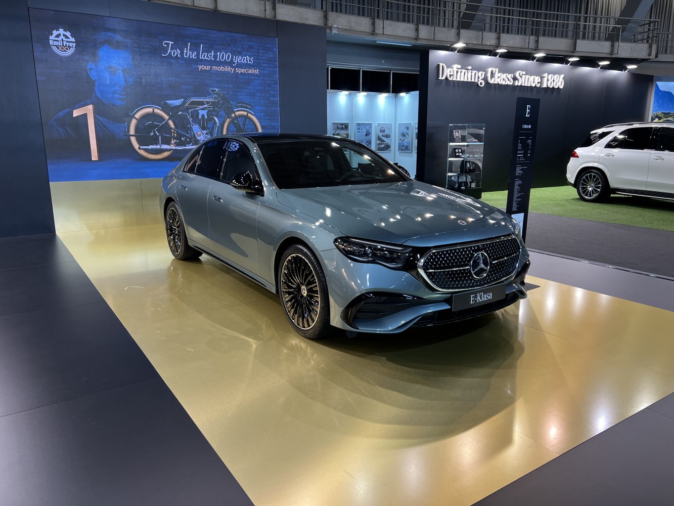 Front view of luxury sedan with AMG multi-spoke wheels and sleek grille