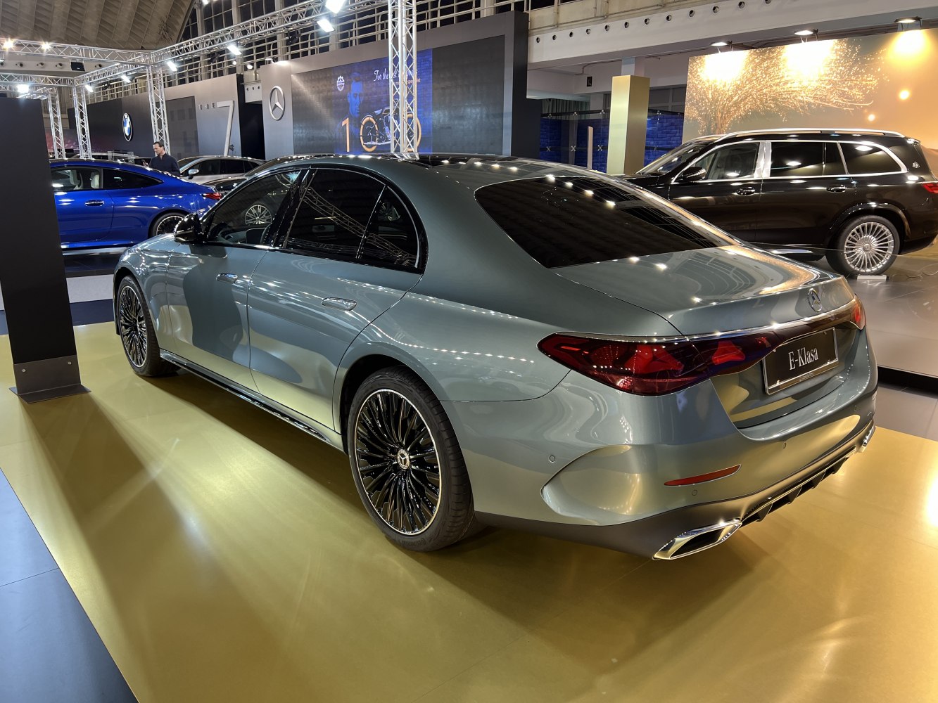 Luxury sedan rear side with LED tail lights and stylish multi-spoke alloy wheels