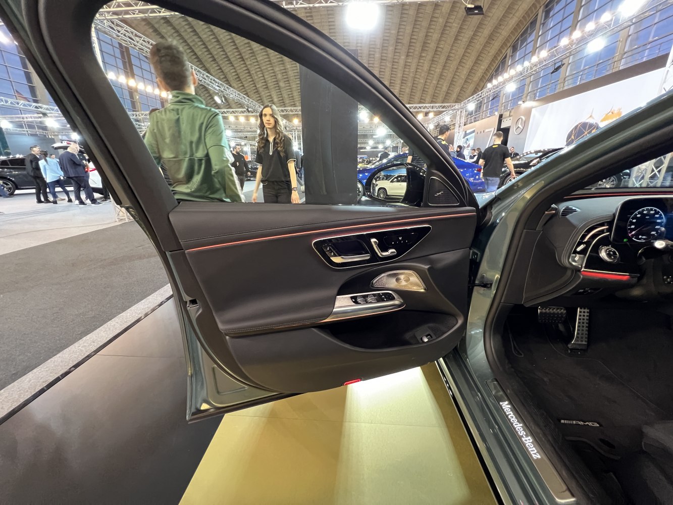 Interior door panel with premium controls and ambient lighting