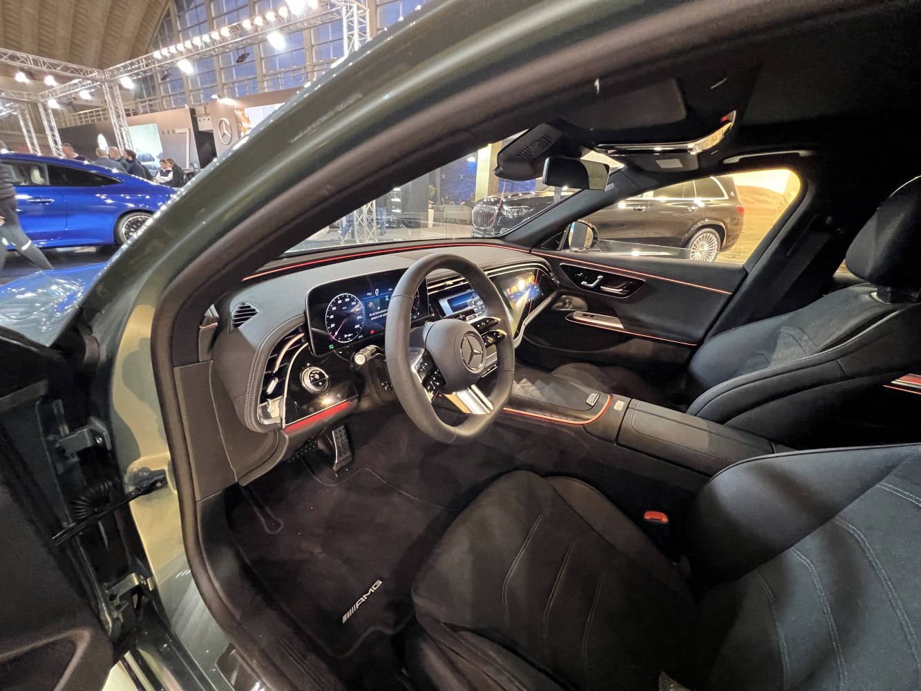 Luxurious black leather interior with AMG branding and digital dashboard