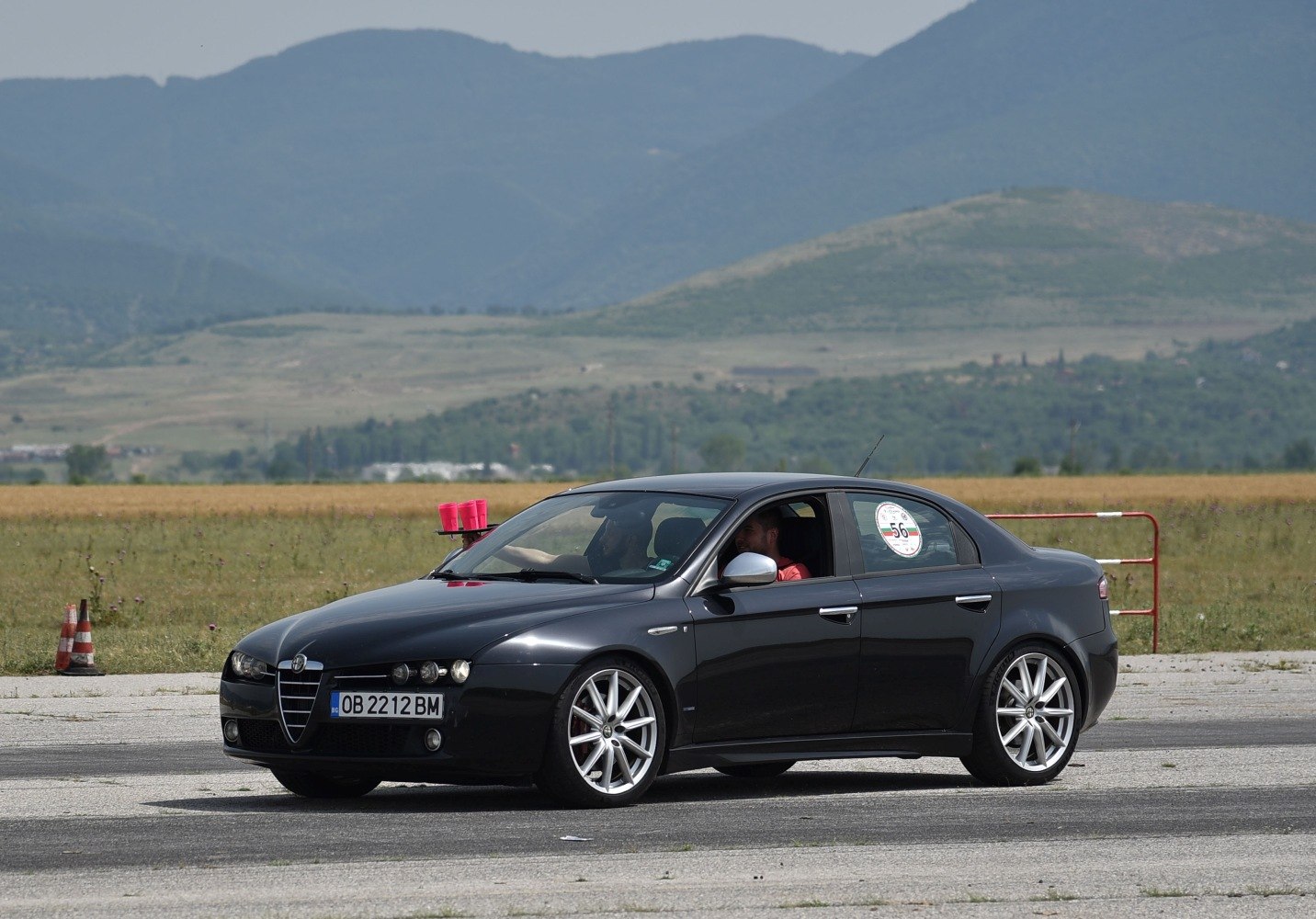 Black sedan with front side view and alloy wheels