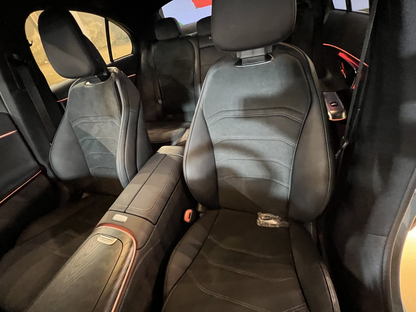 Sporty black leather seats with central console and ambient lighting