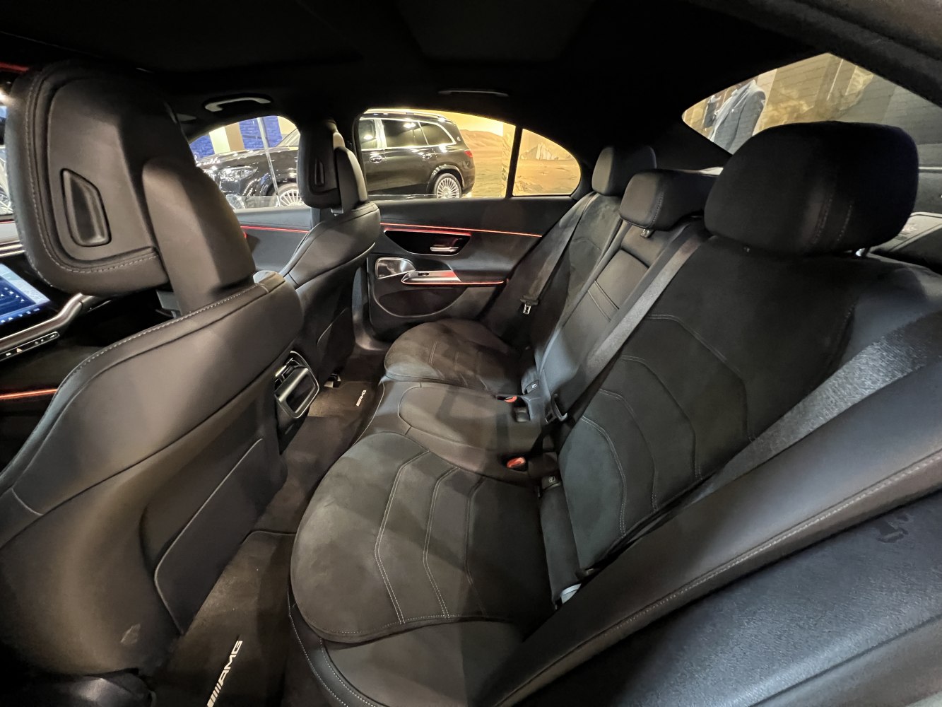 Rear seat interior with leather upholstery and ambient lighting