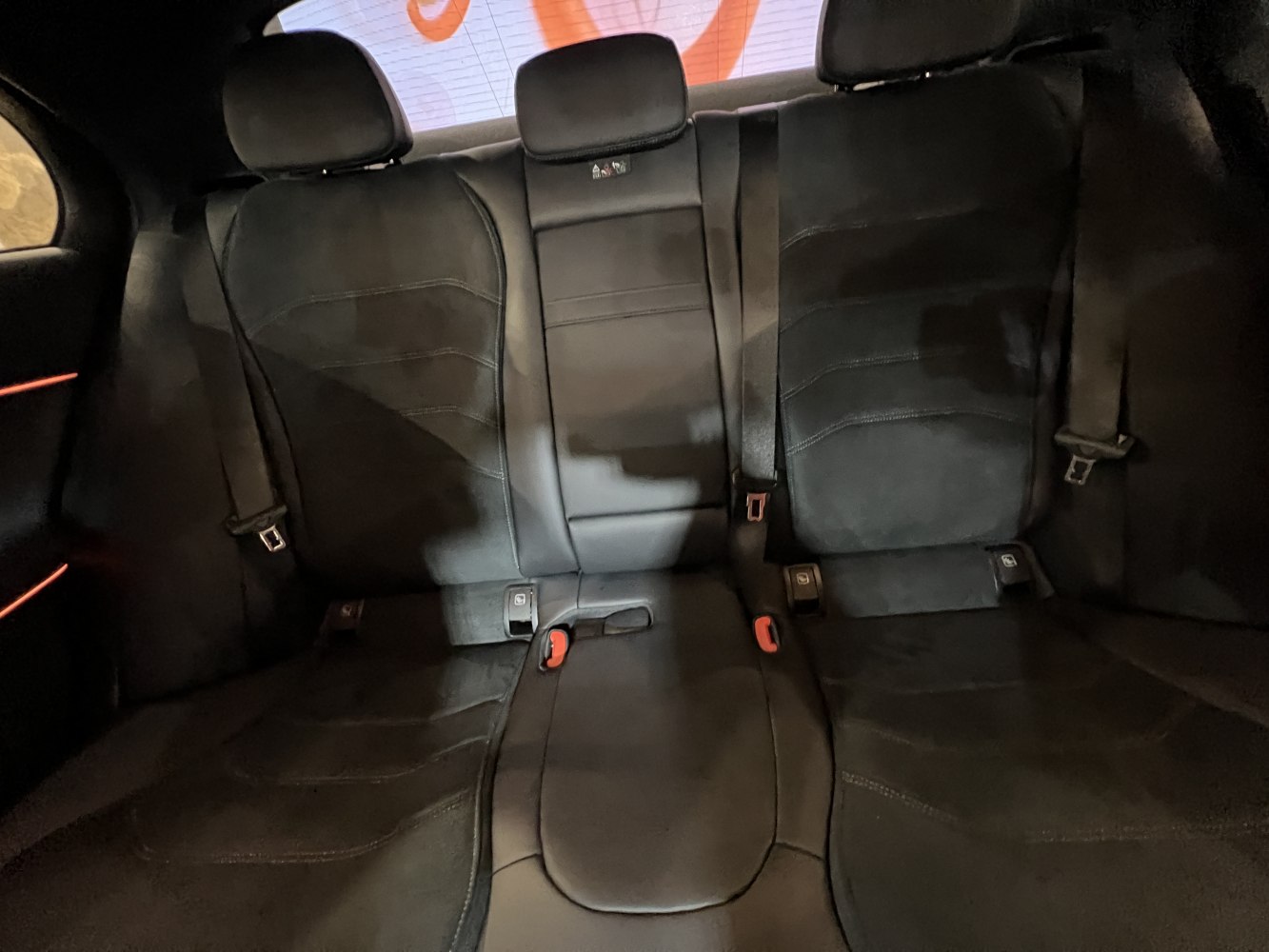 Black leather rear seats with seatbelts and integrated headrests