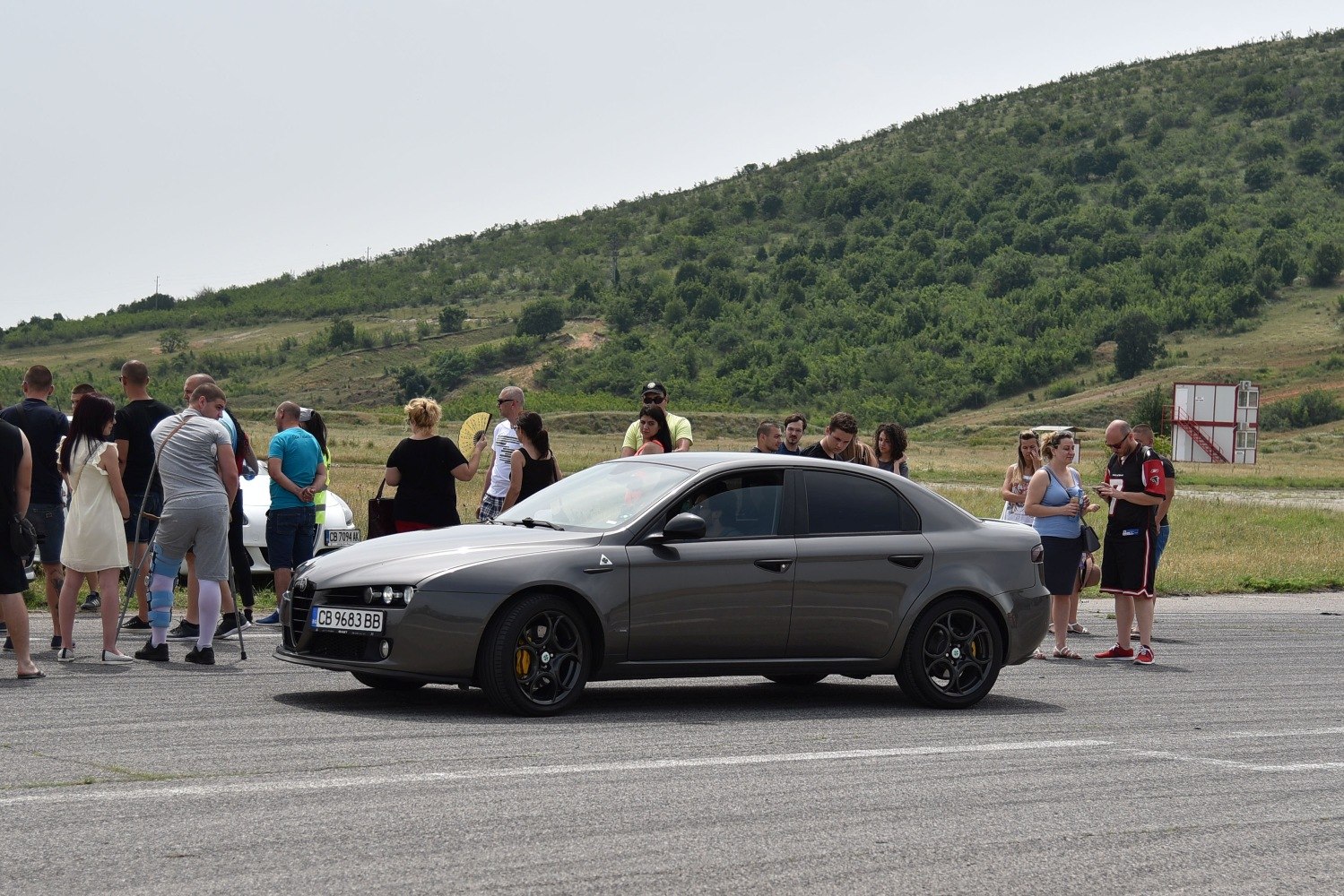 Side view of sedan with black alloy wheels and tinted windows