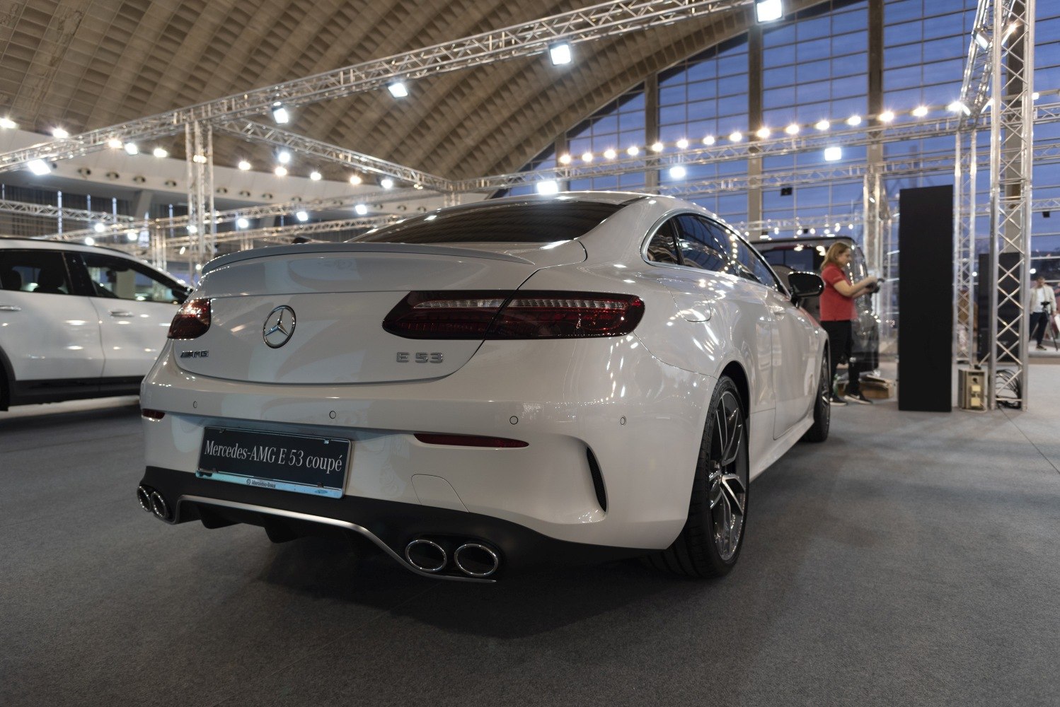 Sporty white coupe rear with quad exhausts and tinted windows