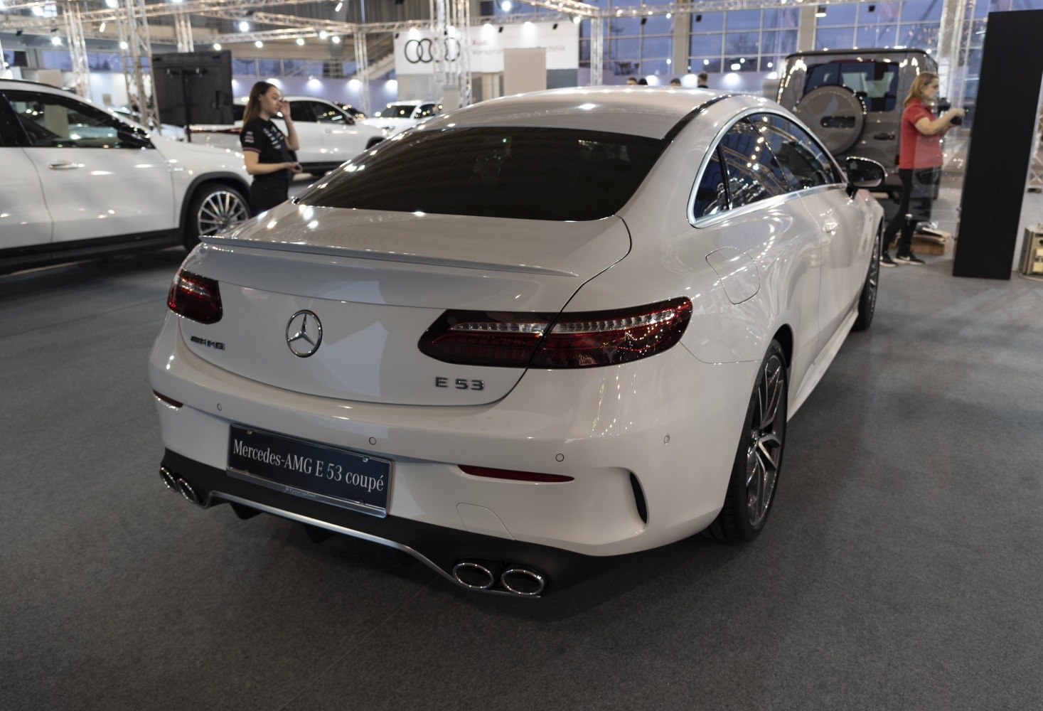 Rear view of a modern luxury coupe with quad exhaust and taillights