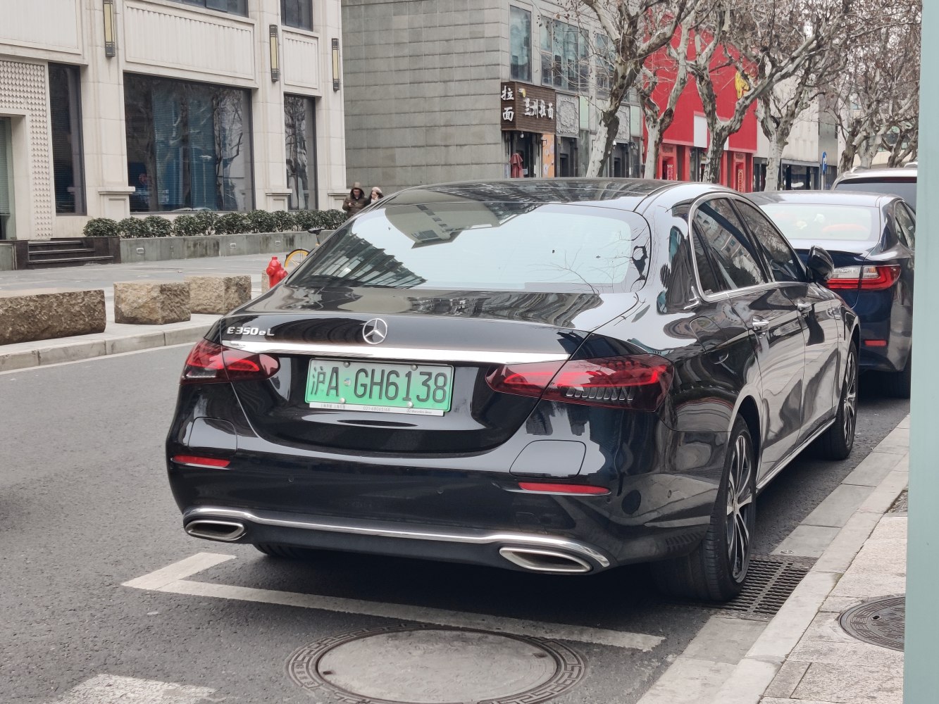 Long wheelbase sedan rear with LED tail lights and dual exhaust outlets