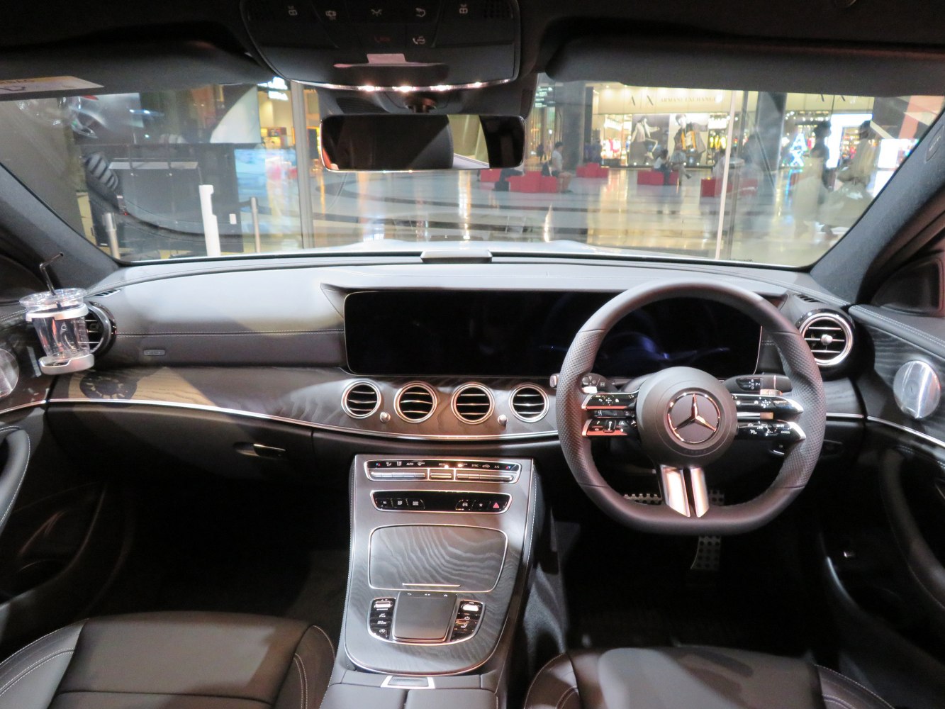 Luxury car dashboard with multifunction steering wheel and central digital display