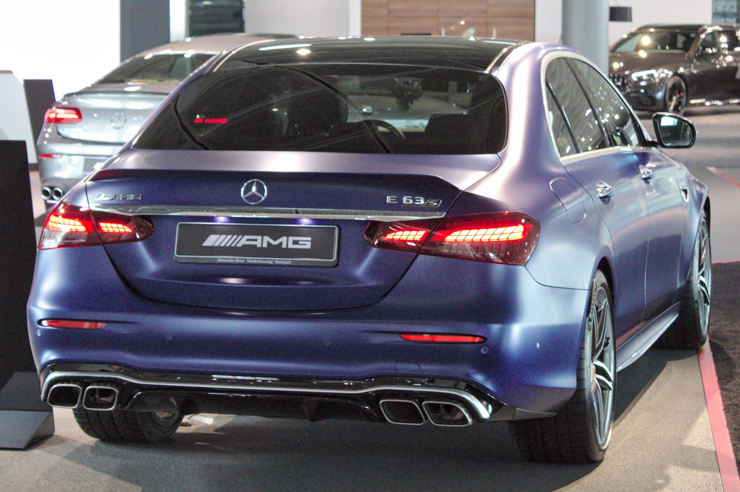 Rear view with AMG quad exhaust and LED taillights in matte blue finish