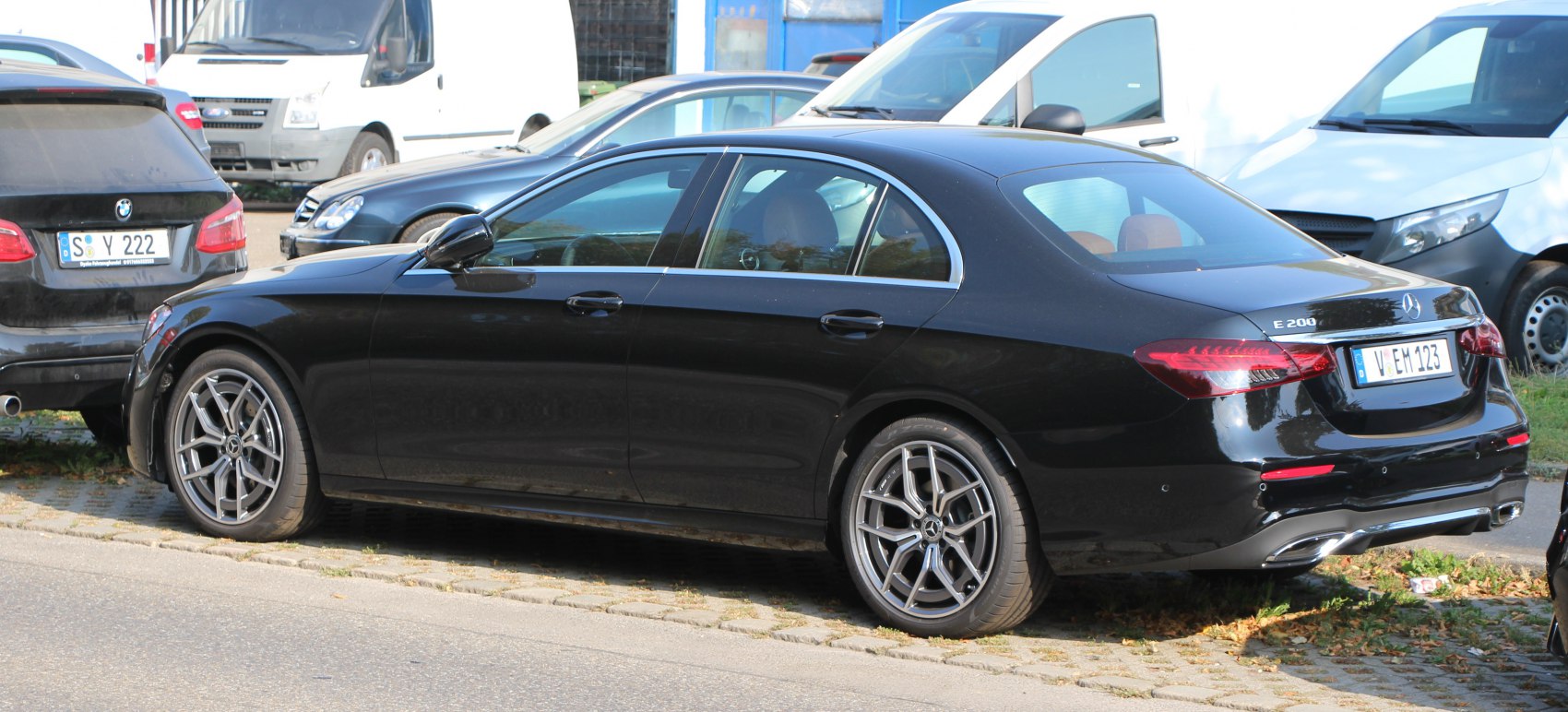 Rear and side view of a luxury sedan with alloy wheels and smooth curves