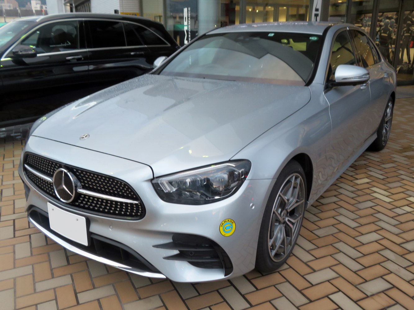 Silver luxury sedan with LED headlights and sporty front grille