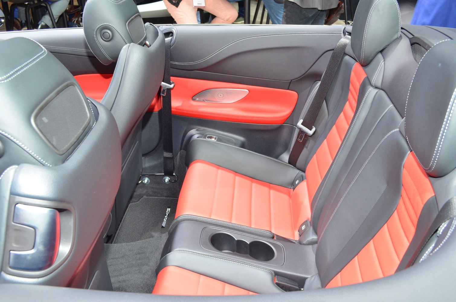 Red and black leather rear seats with cup holders and seatbelts