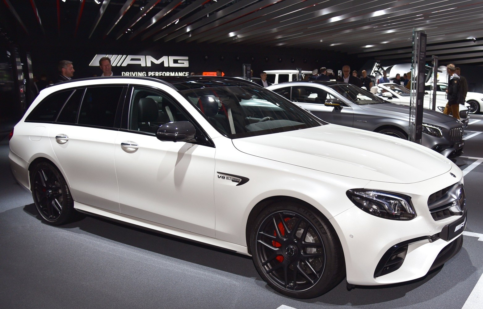 White AMG wagon with V8 Biturbo badge, black wheels, red brakes