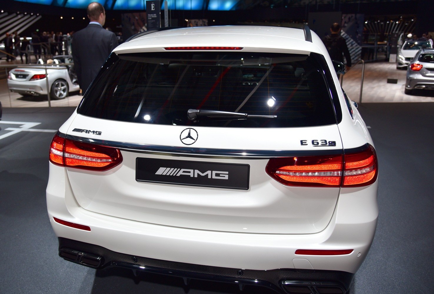 Rear view with AMG badge, taillights, rear window wiper, and dual exhausts