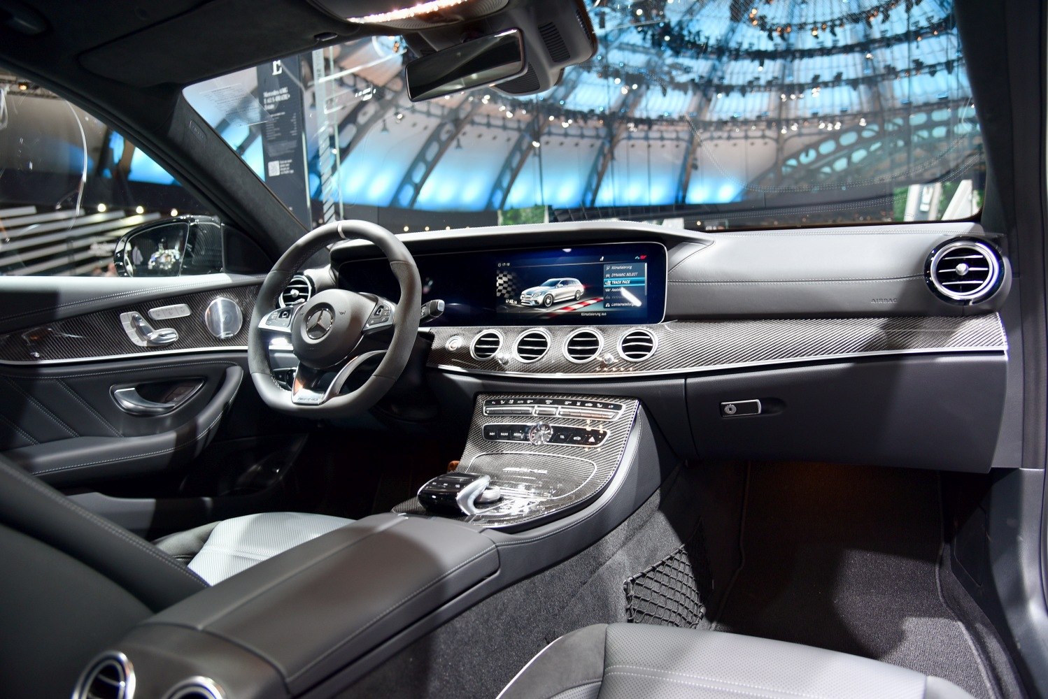 Luxury car interior with digital infotainment and carbon fiber trim