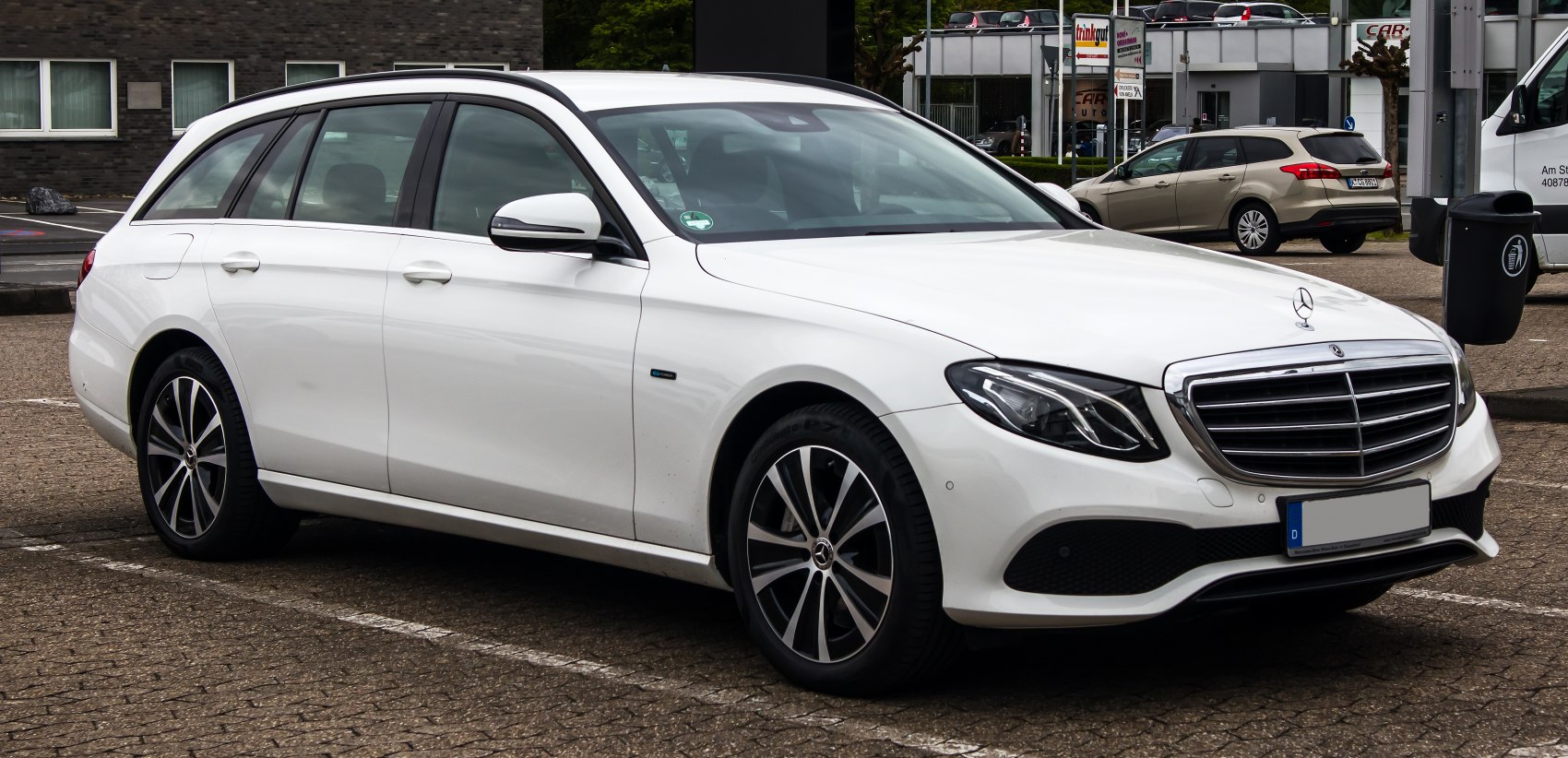 White station wagon with alloy wheels and LED headlights