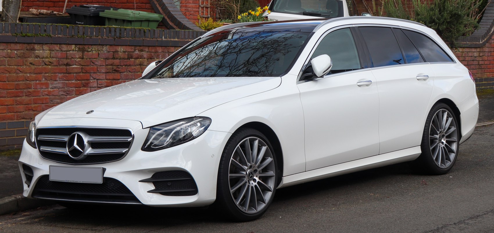 White station wagon with sleek LED headlights and large alloy wheels