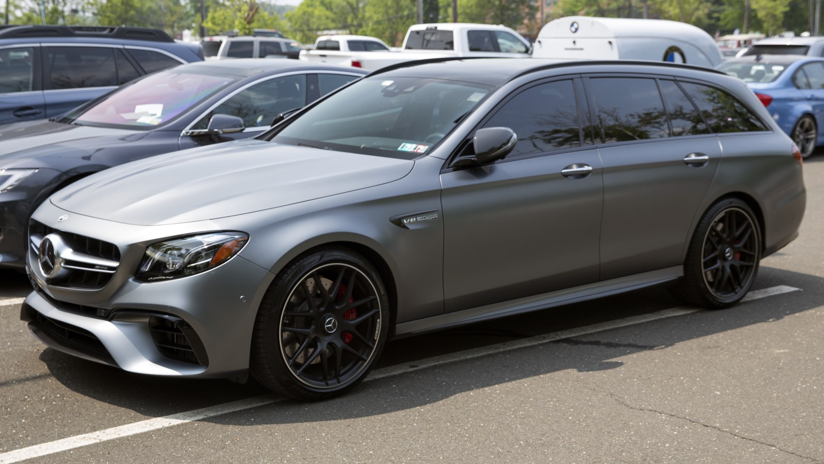 Matte gray wagon with AMG wheels and V8 BiTurbo badge, side view