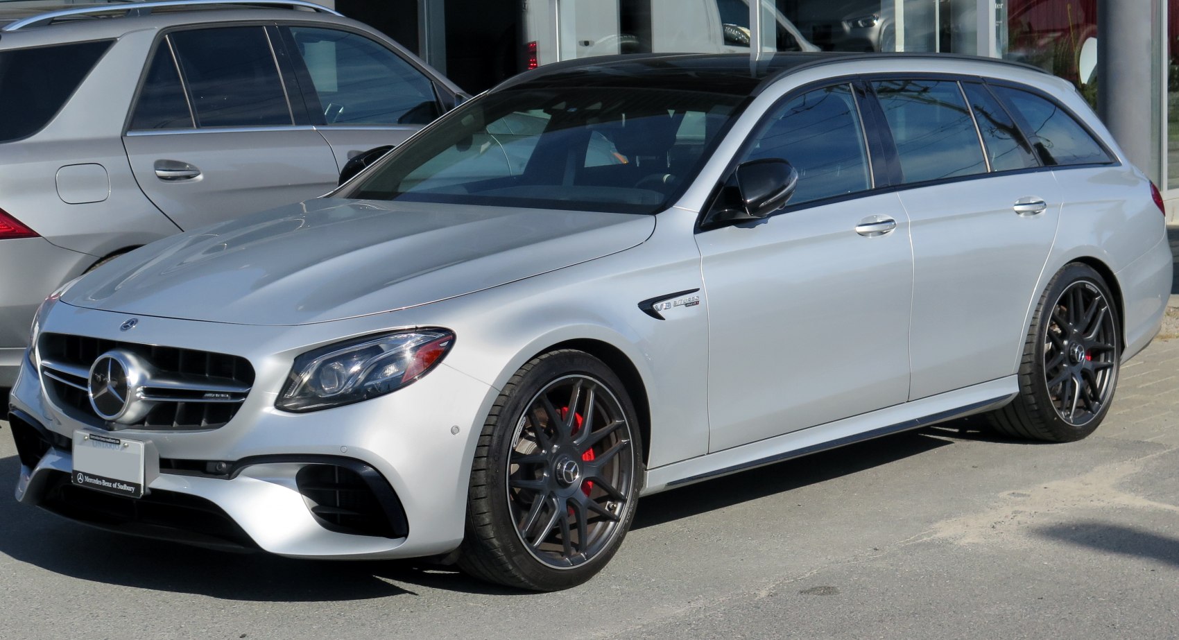 Sporty front-side view with grille, dark multi-spoke wheels, and aerodynamic design