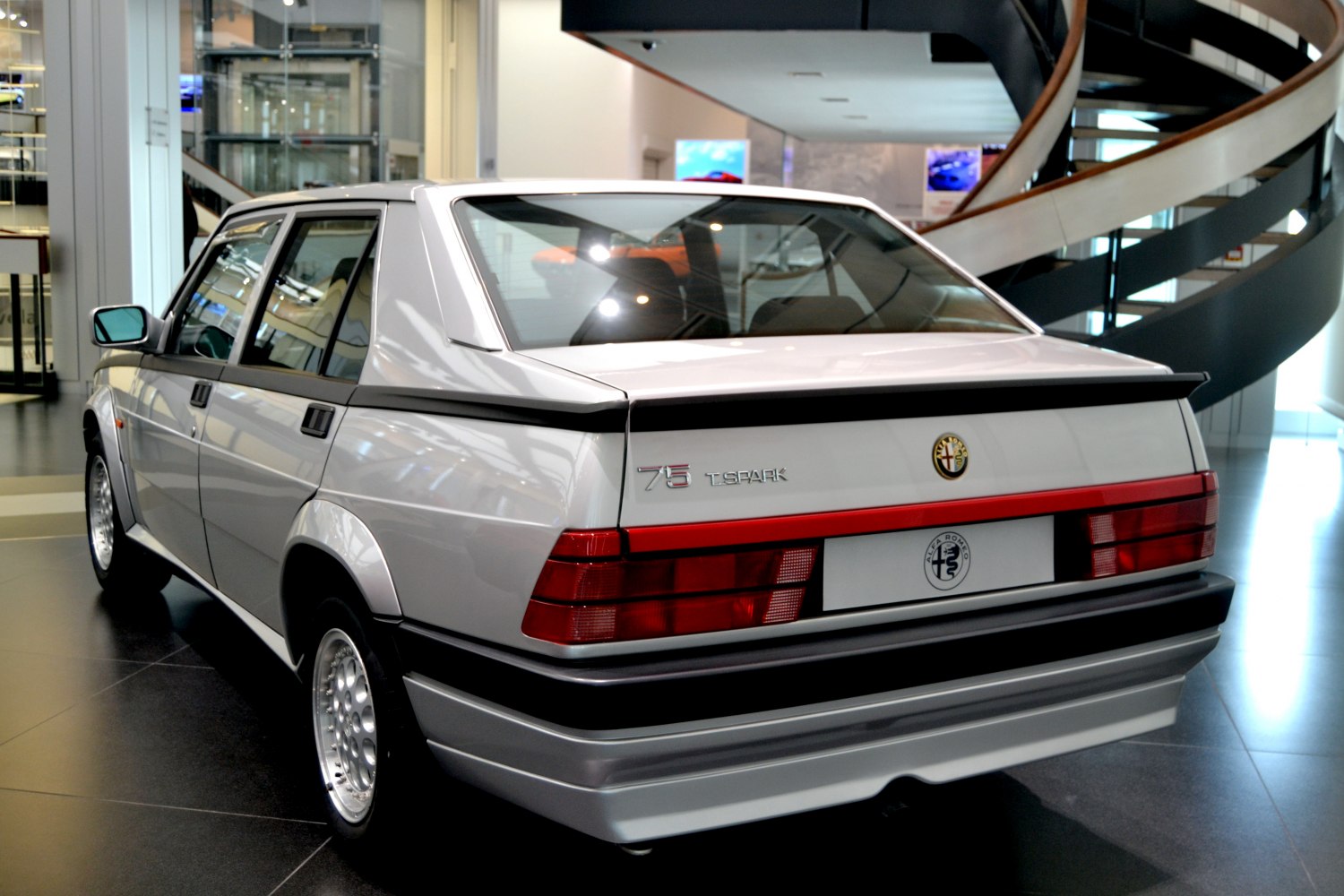 Rear view with spoiler and large taillights of a classic sedan.