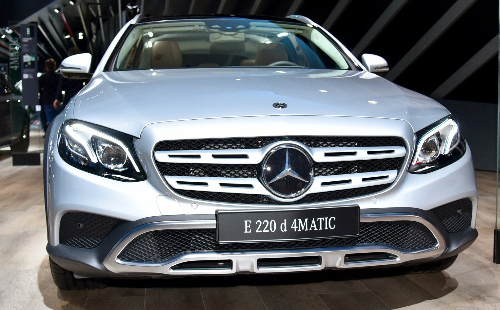 Close-up of car grille, headlights, and front bumper with 4MATIC badge