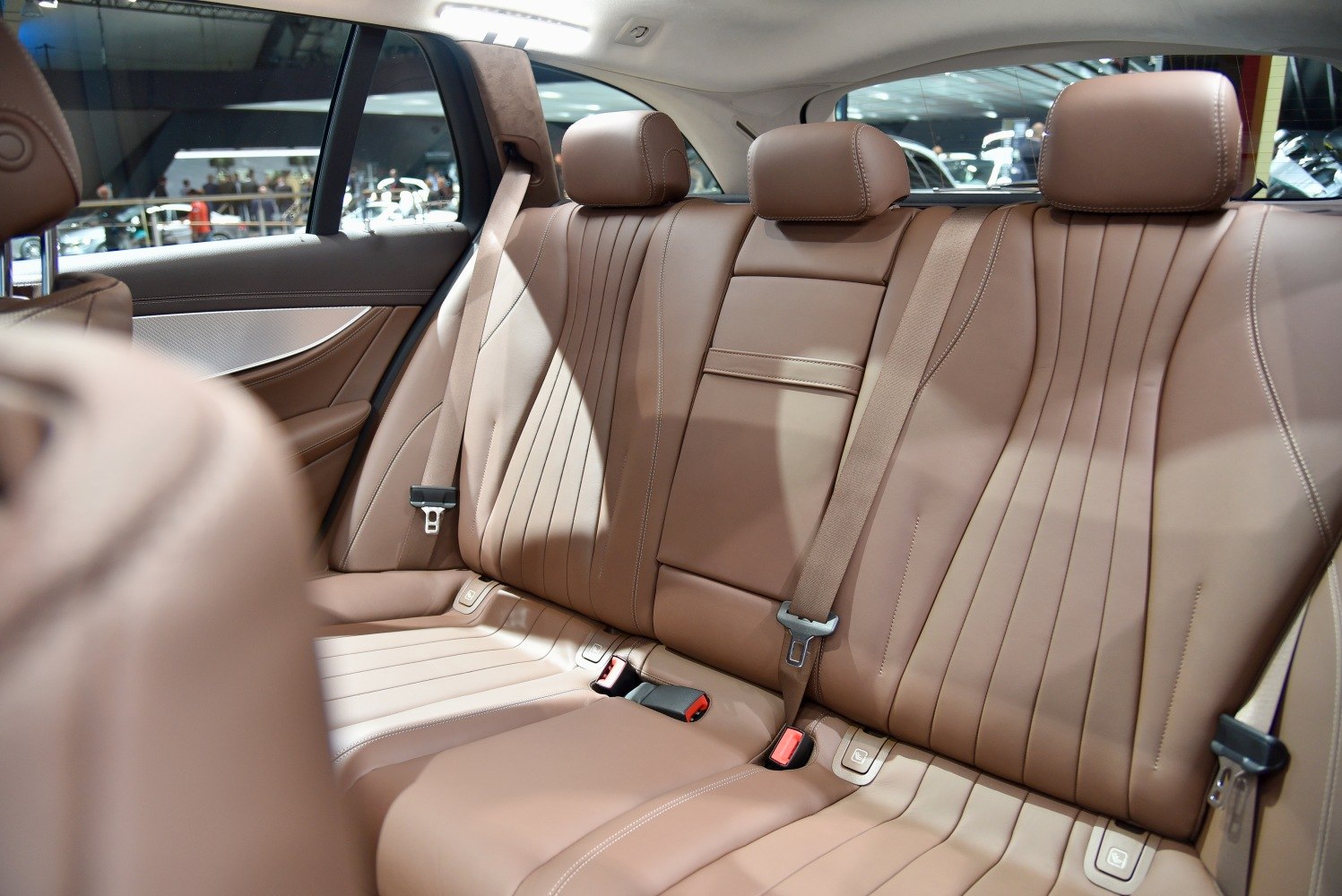 Brown leather rear seats with headrests and seatbelts