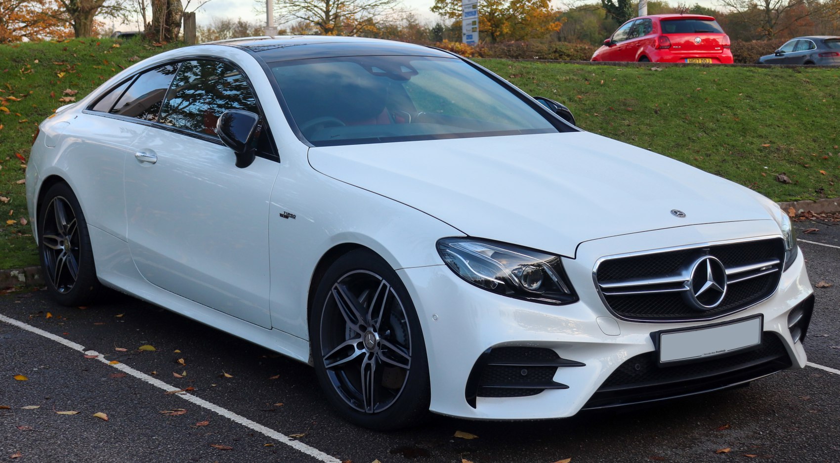 Sleek front headlights and sporty alloy wheels on luxury coupe