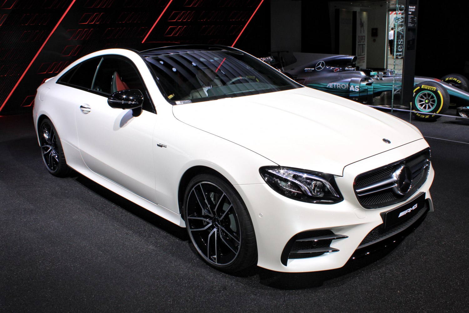 White coupe with AMG wheels, front grille, and modern headlights
