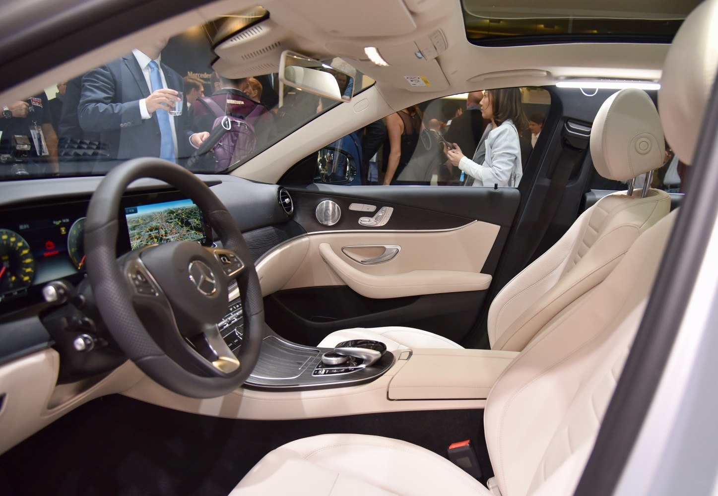 Luxurious beige leather interior with digital dashboard and advanced controls