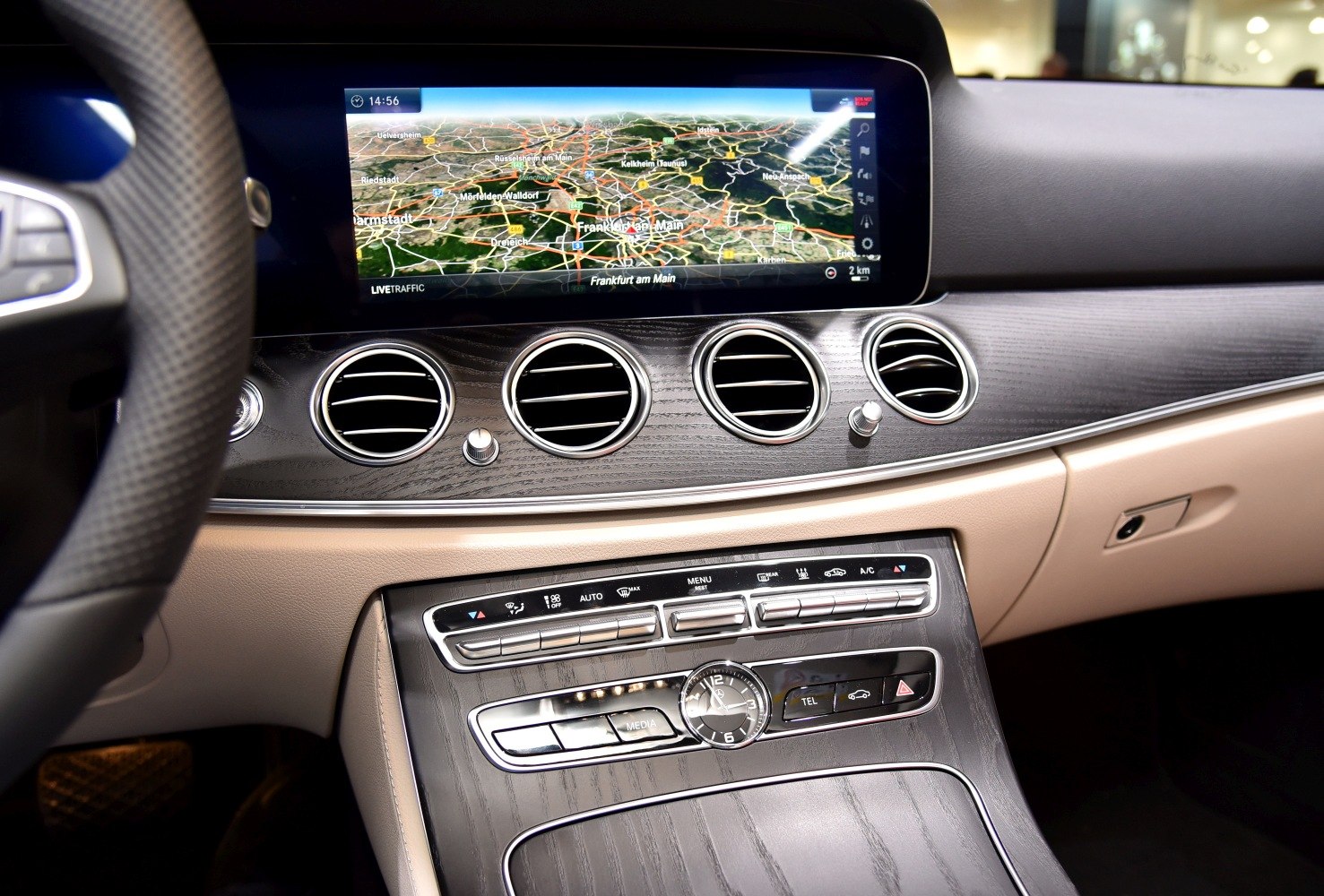Dashboard with navigation screen, wood trim, and air vents