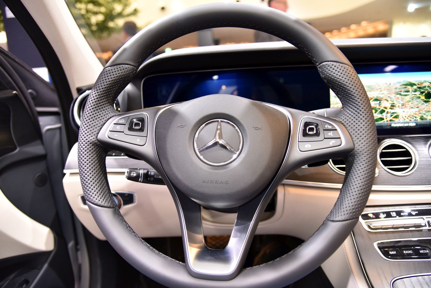 Steering wheel with multifunction buttons and digital display in modern luxury interior