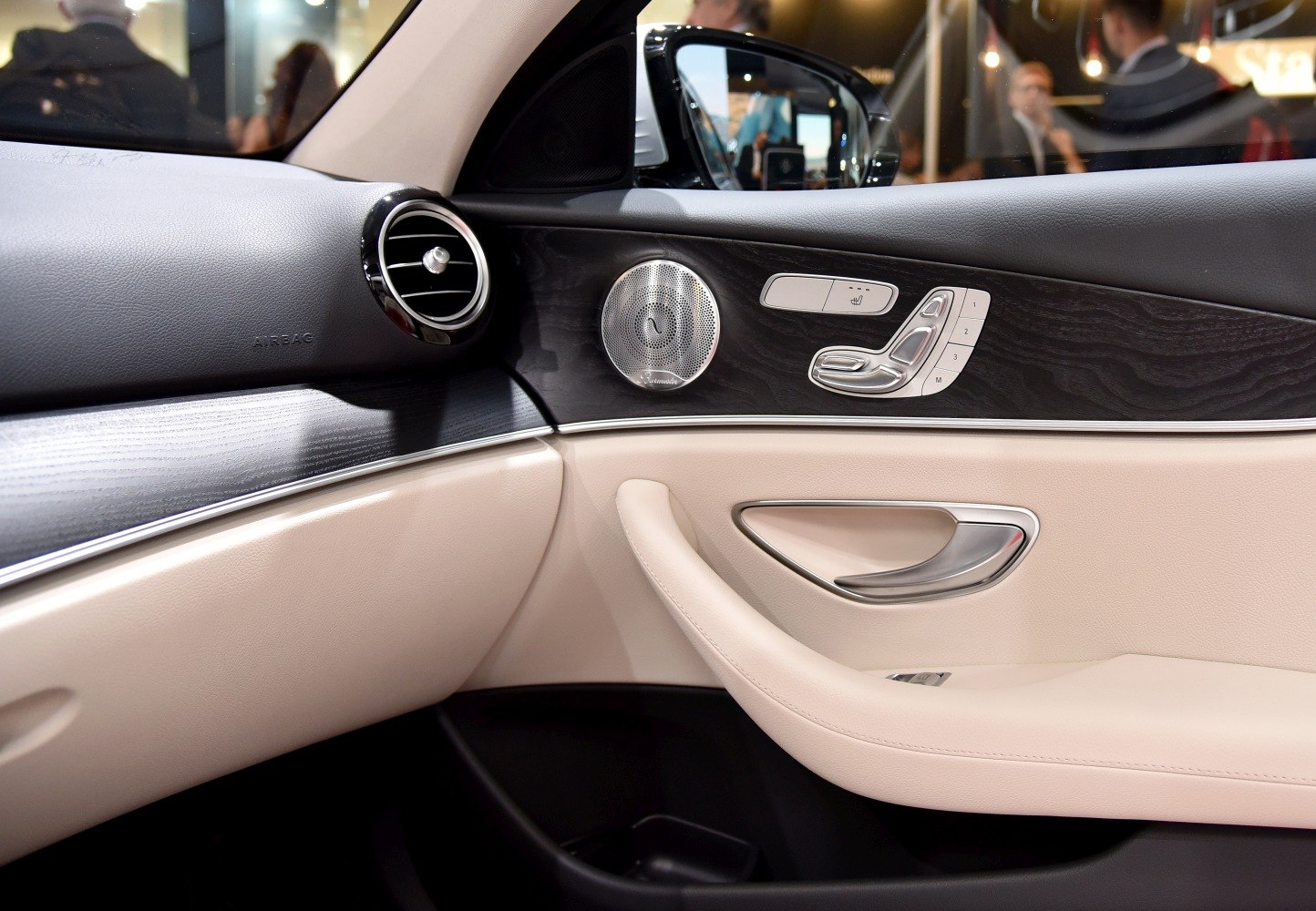 Interior door panel with seat controls and round air vent