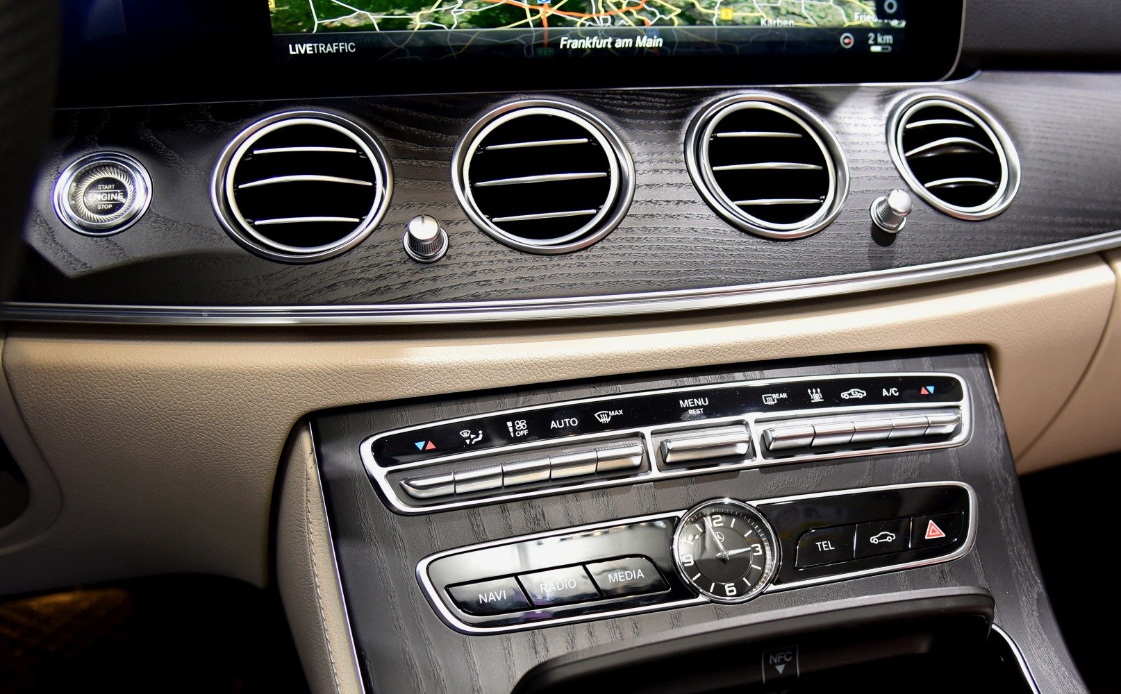 Dashboard air vents and analog clock with climate control buttons