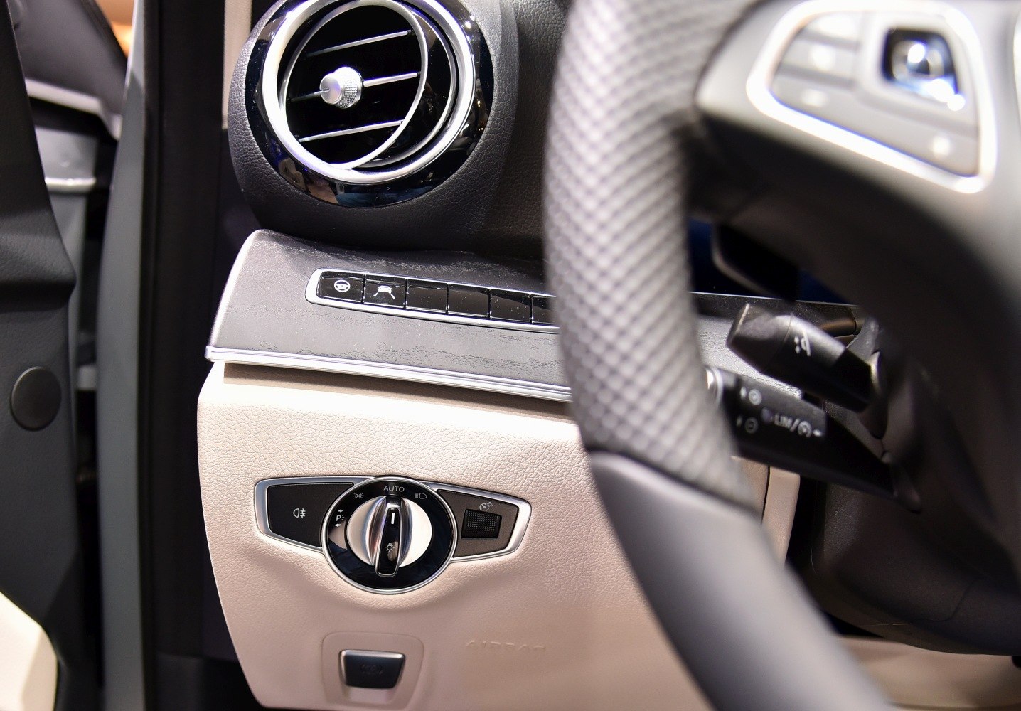 Close-up of air vent and light control switches inside vehicle