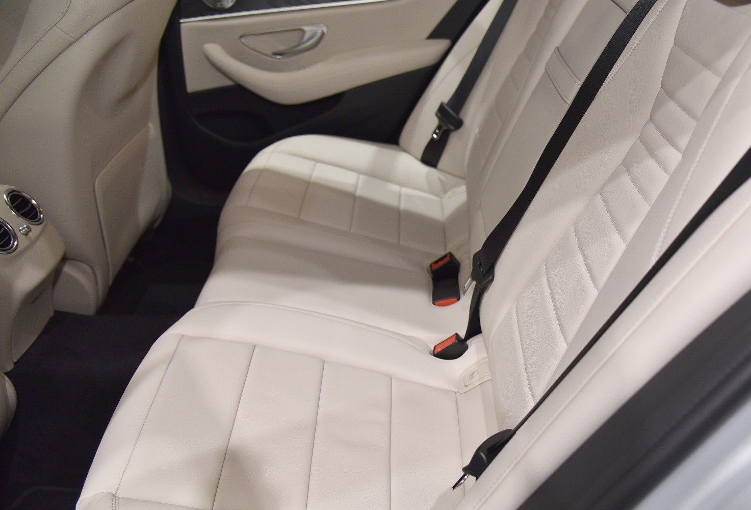 Beige leather rear seats with seat belts and rear air vents