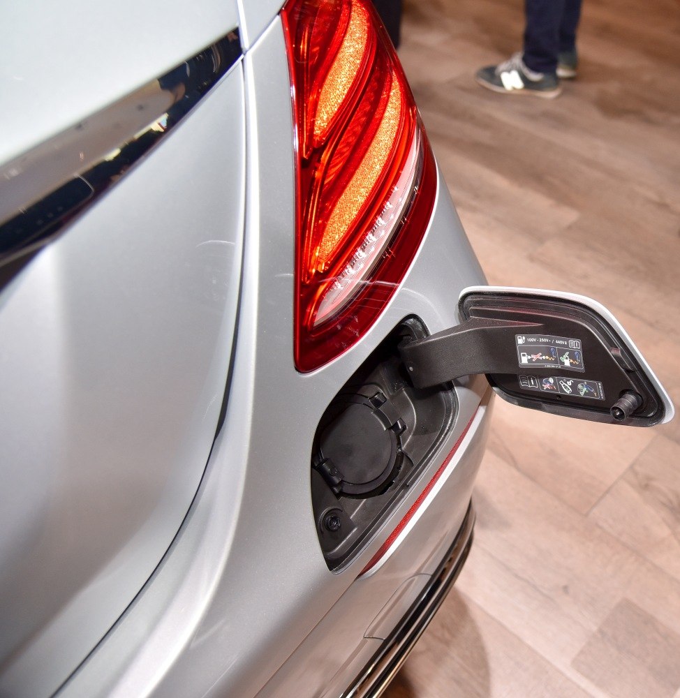 Rear LED tail light and electric charging port on silver car rear side