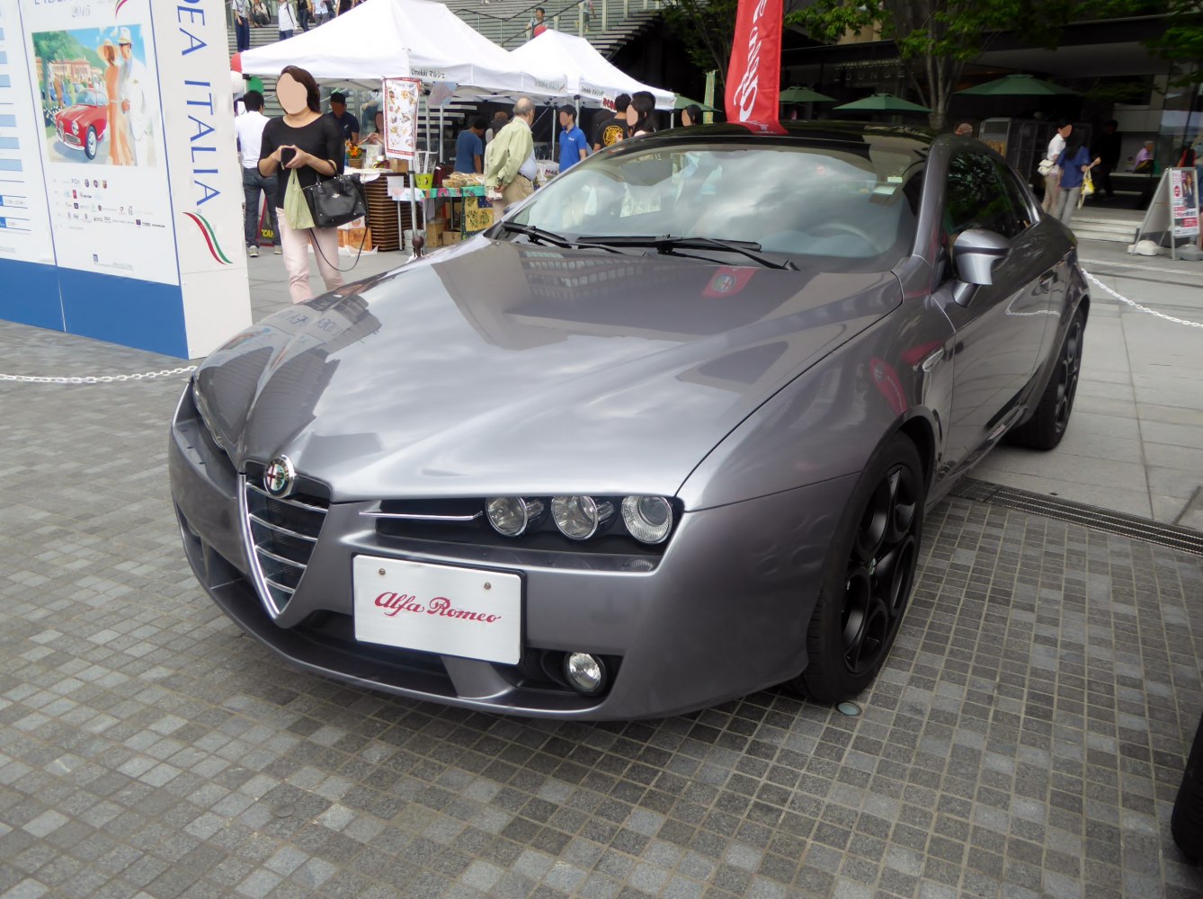 Sleek front view with V-shaped grille and triple headlights
