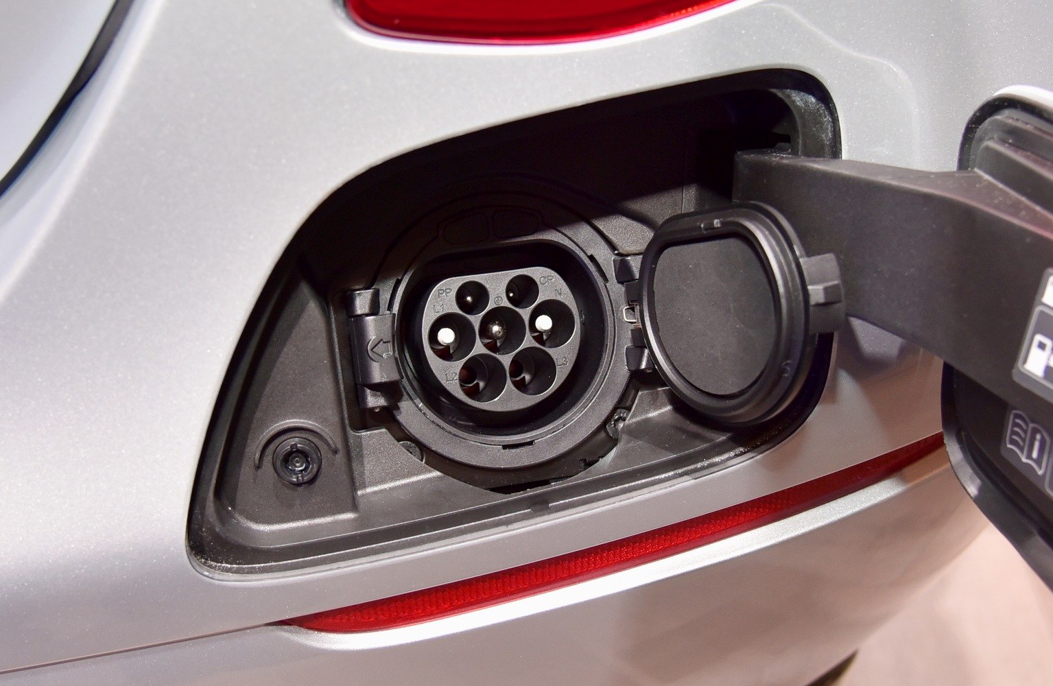 Close-up of electric vehicle charging port and connector.