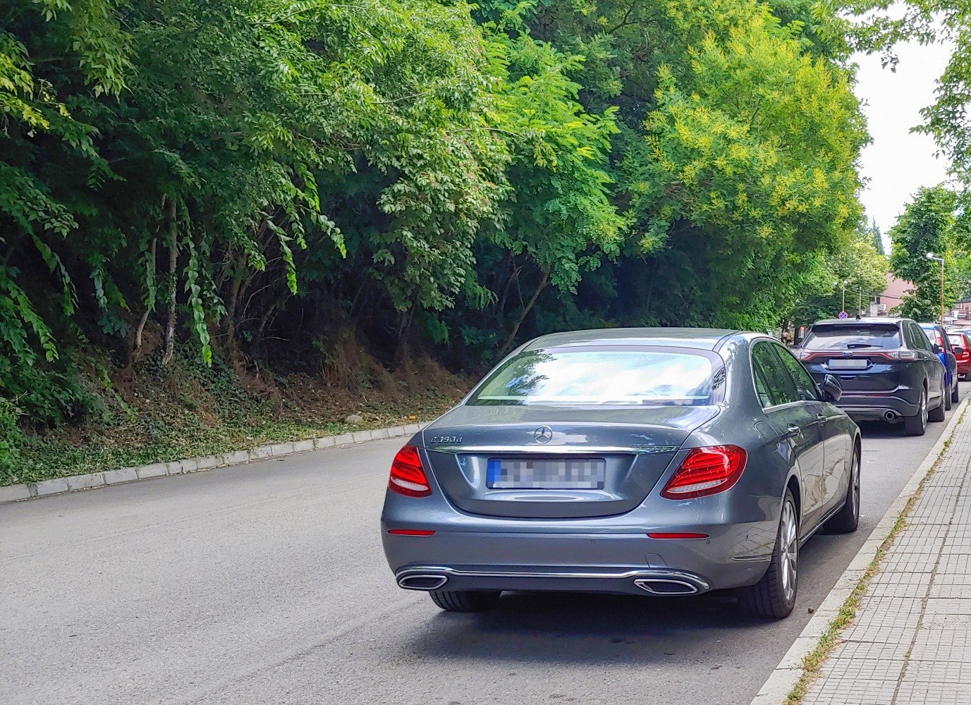 Rear view of a luxury sedan with distinct tail lights and dual exhausts