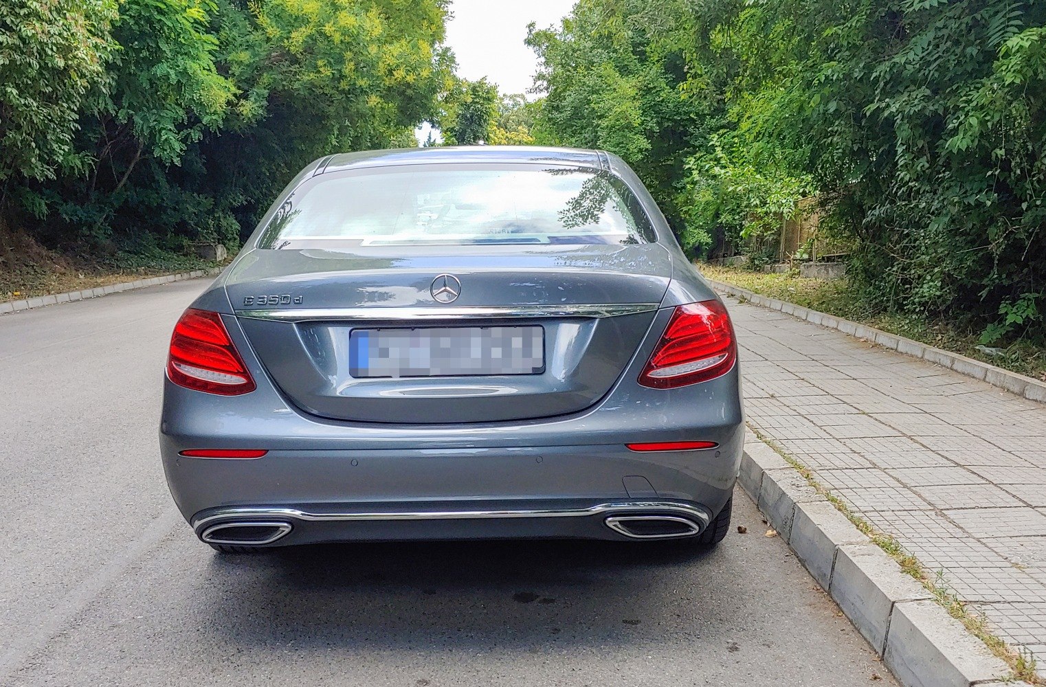 Rear view with tail lights and dual exhausts.