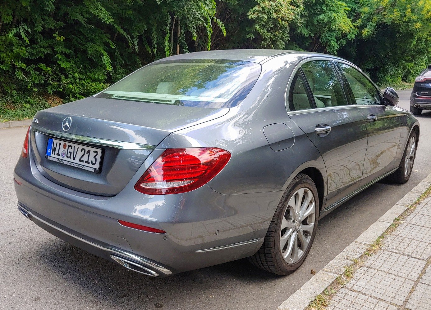 Rear and side view with tail lights and alloy wheels