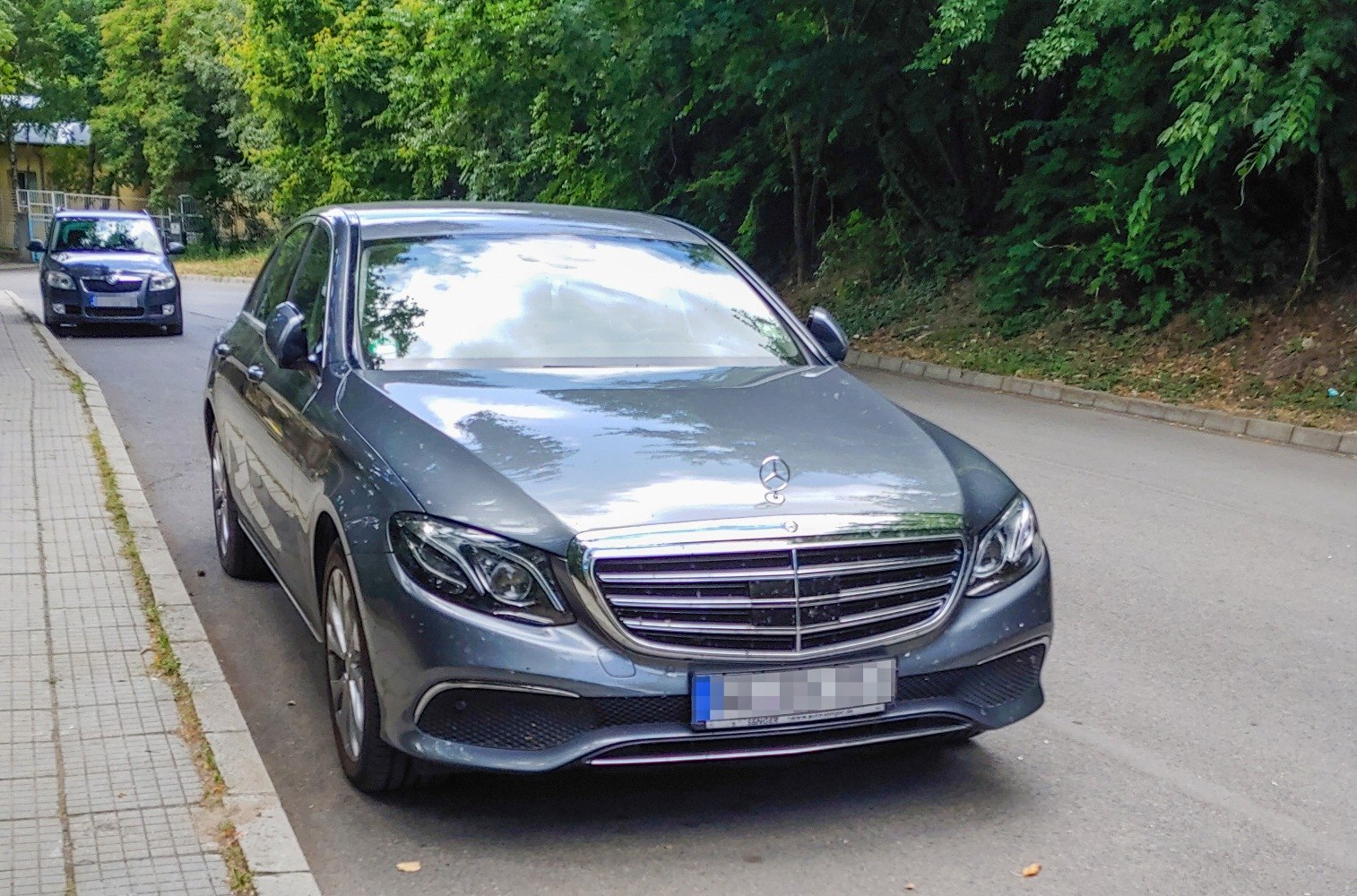 Front view of a luxury sedan with chrome grille and LED headlights