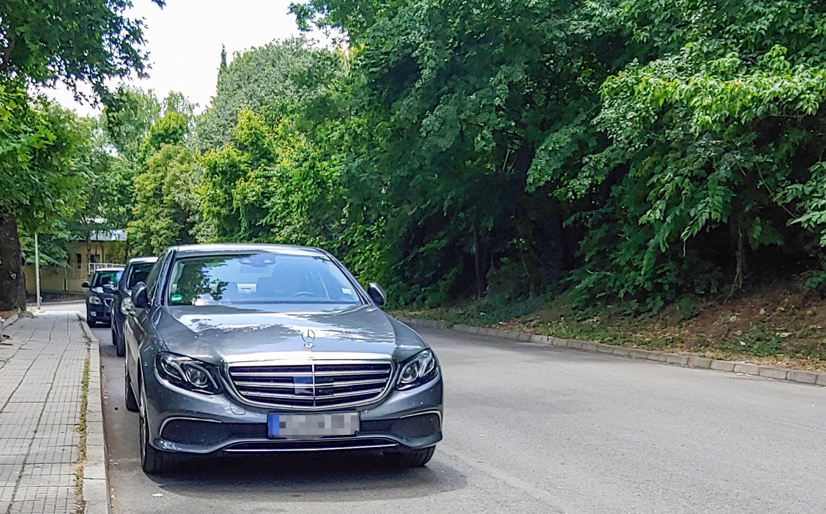 Front view of luxury sedan with wide grille and LED headlights