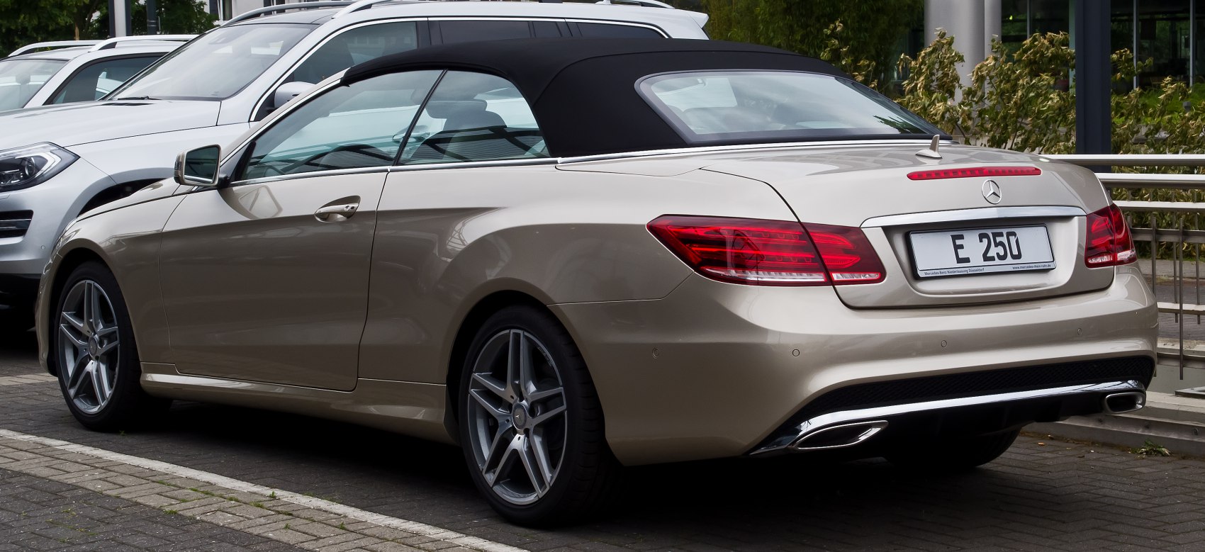 Rear-side view of a convertible with soft top and sporty wheels