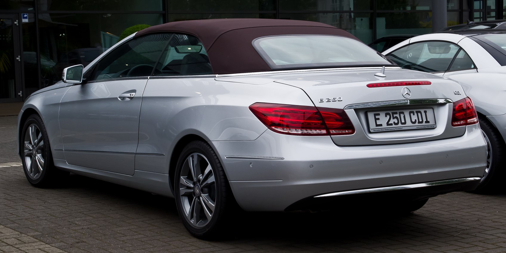 Rear view of silver convertible with soft top and sleek taillights