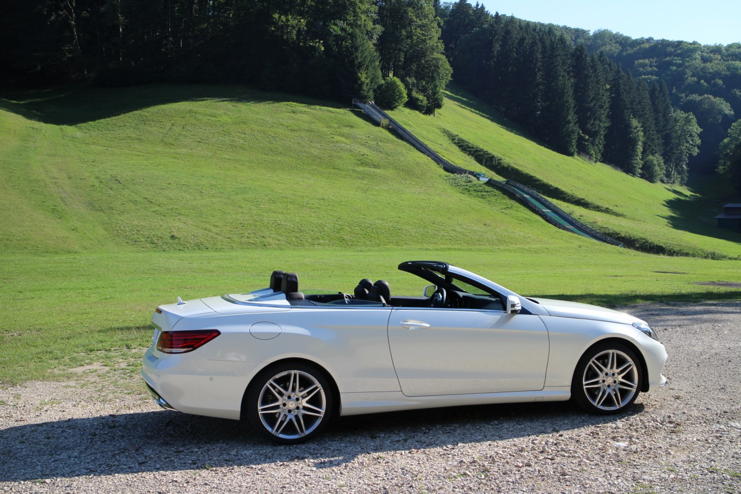 Convertible luxury vehicle with lowered roof and alloy wheels