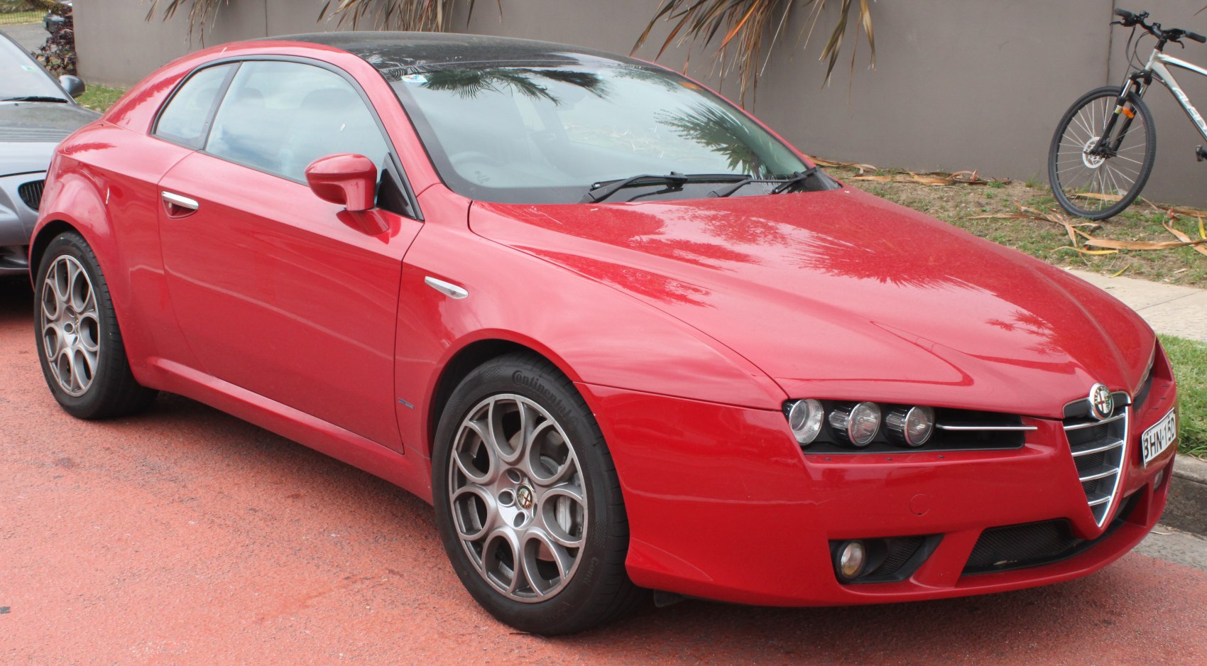 Front three-quarter view of a sporty coupe with triple headlights