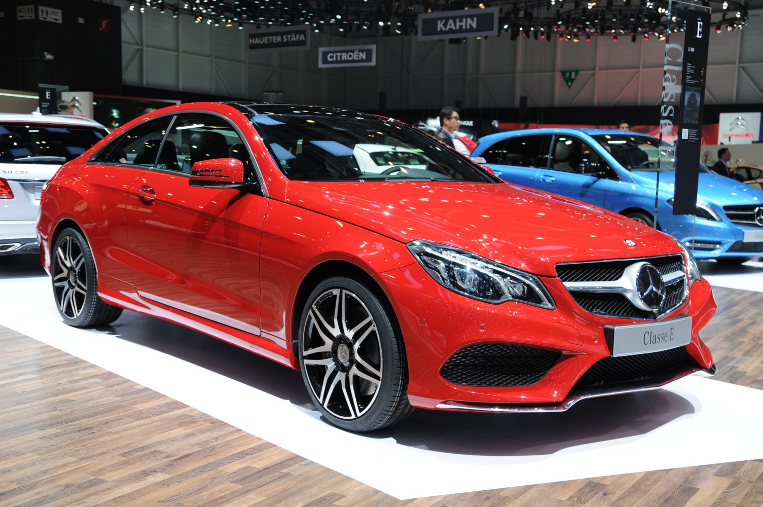 Sleek red coupe with distinctive headlights and sporty alloy wheels